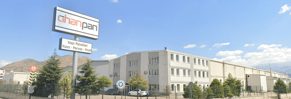 Exterior view of the Cihanpan Door factory, showcasing its large-scale production facility for wholesale interior wooden doors and internal door exports.